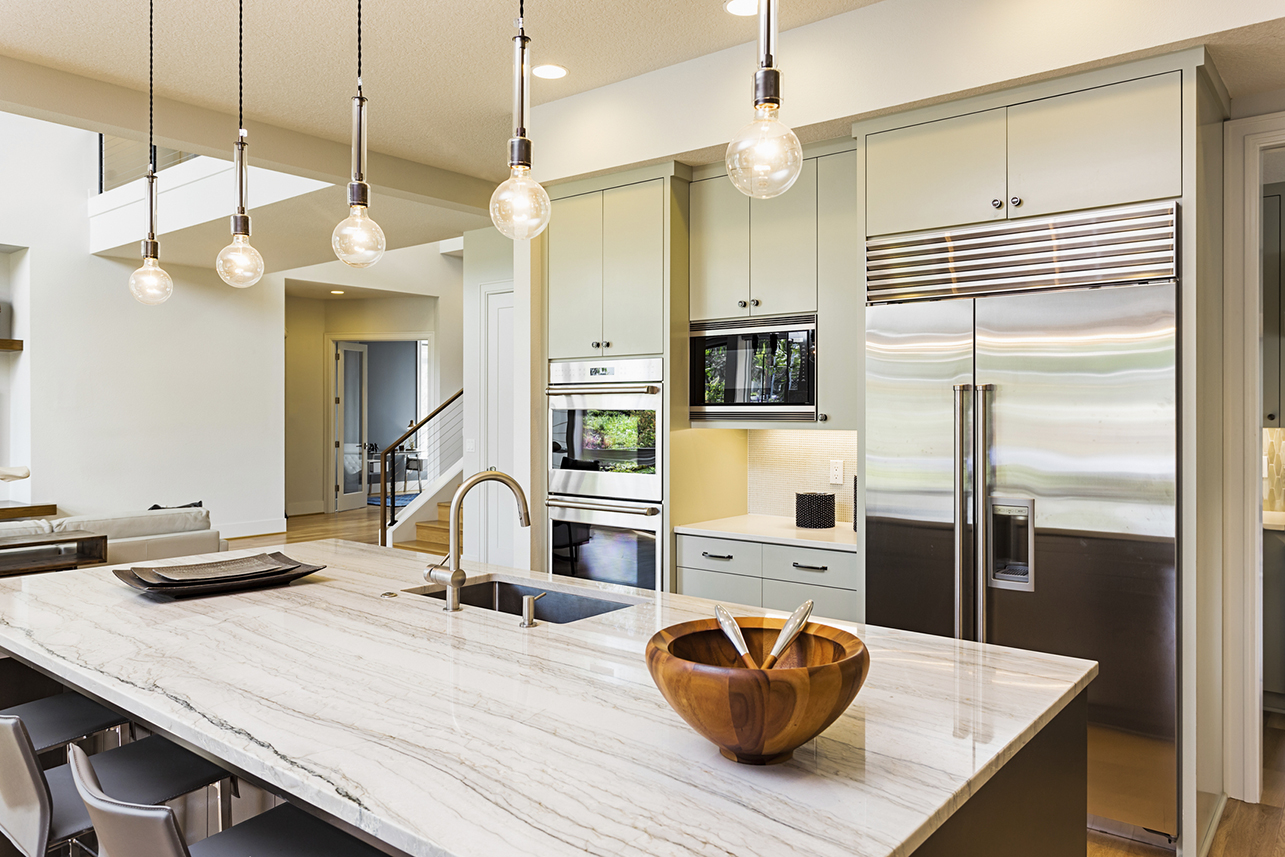 Kitchen with Island, Sink, Cabinets, and Hardwood Floors