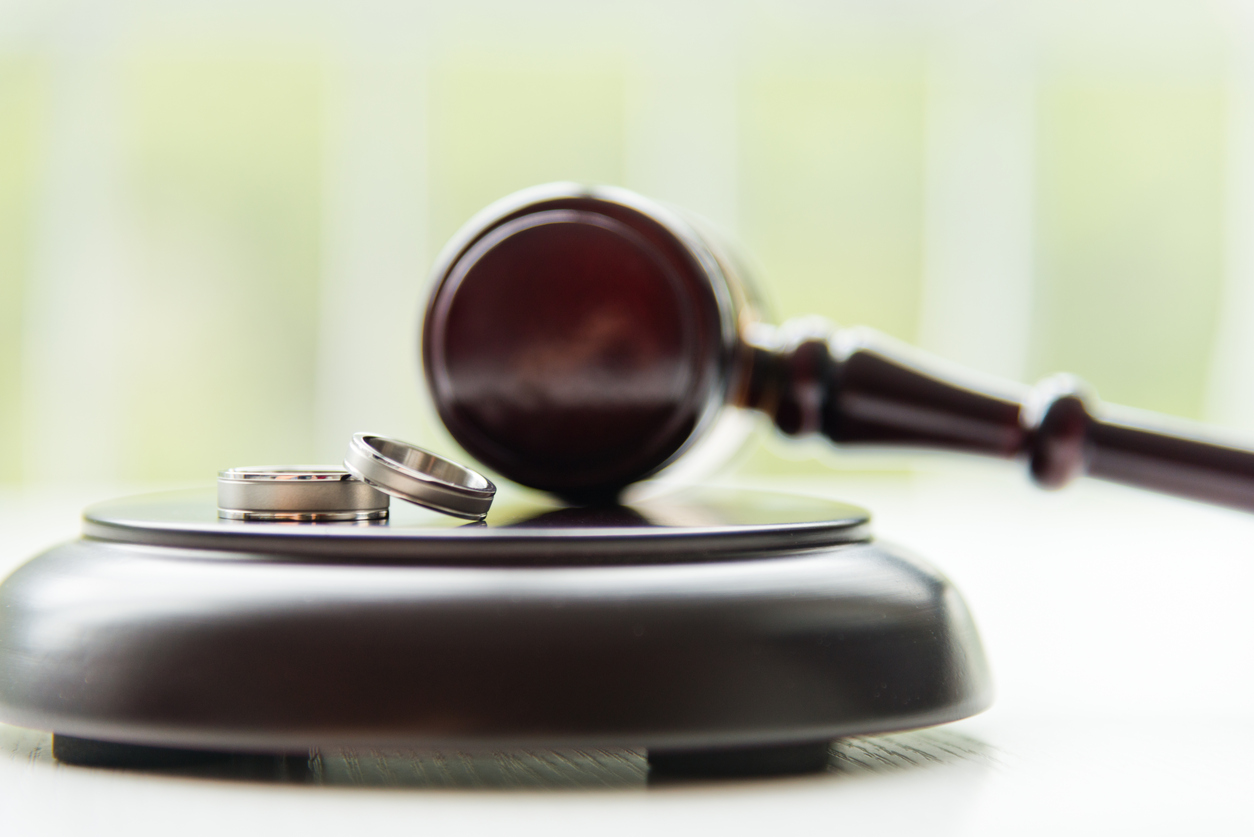 Wedding bands sitting on a judges gavel